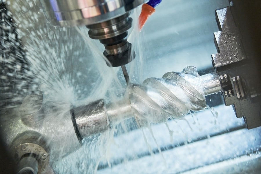 CNC lathe rotates in a custom fabrication shop