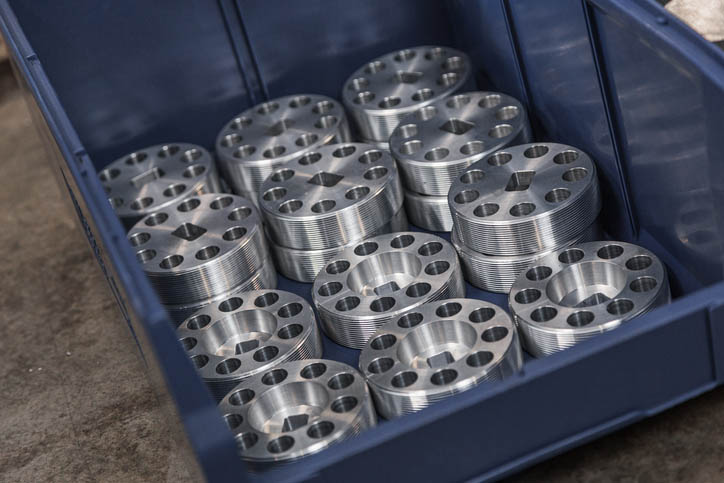 19 CNC-machined metal parts in blue box