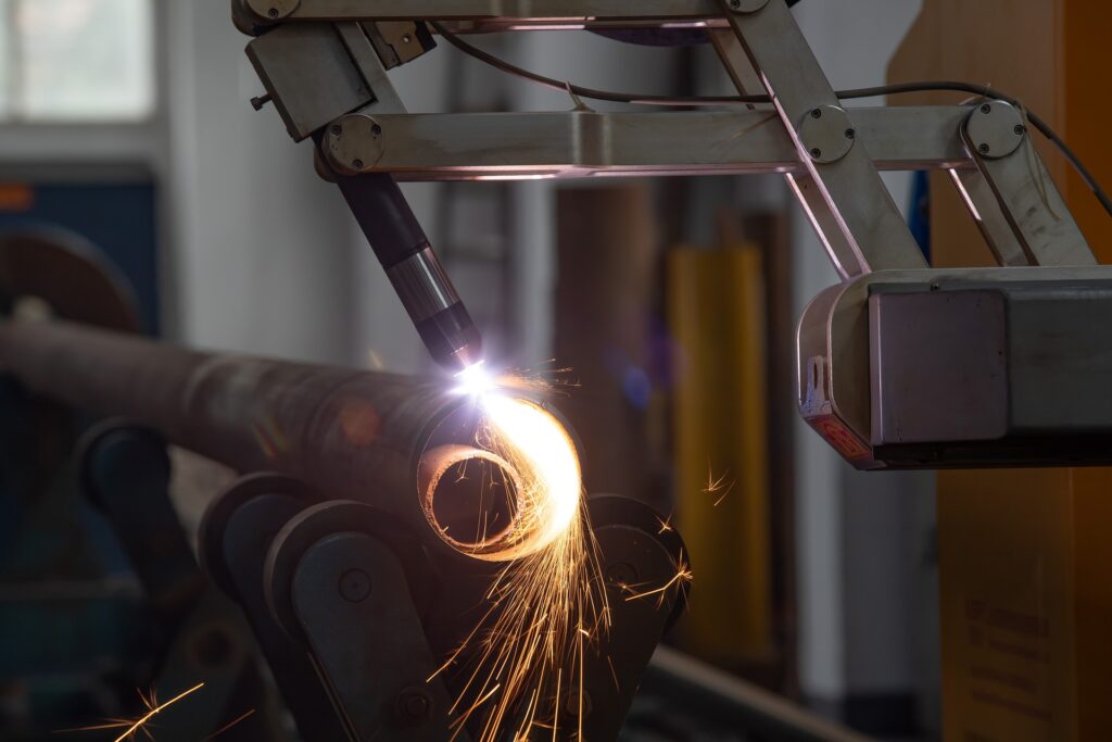 CNC machine cuts metal tube